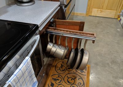 sliding rack containing pots and pans