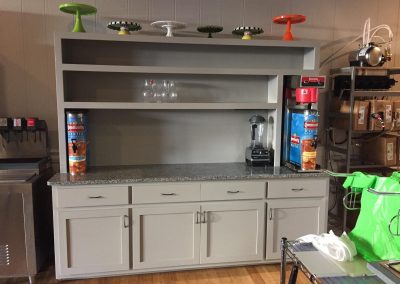 Coffee bar with gray cabinets and shelves.