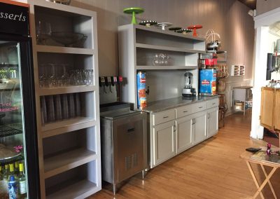 Coffee bar with gray cabinets and shelves.