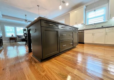 Kitchen island with black cabinets and drawers.