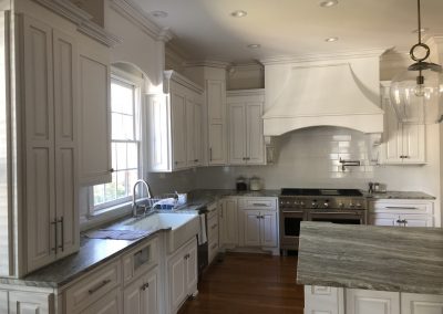 Beautiful kitchen with white cabinets and marble countertops.