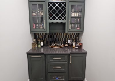 Dark green wine cellar with glass doors.