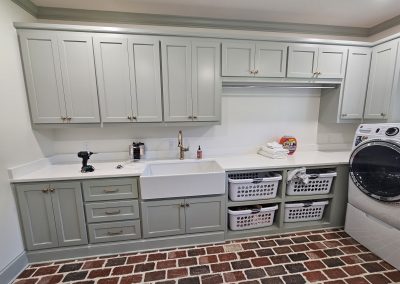 Gray cabinets and laundry prep area.