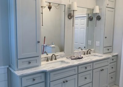 Vanity with twin sinks, light blue gray paint.